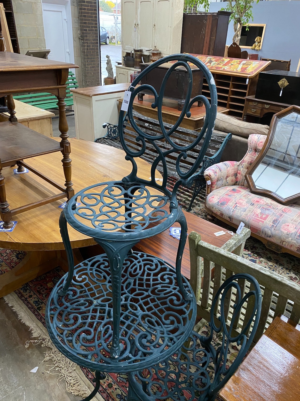 A green painted aluminium cafe table and two chairs